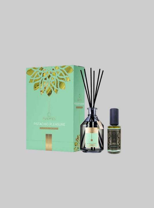 Roomoi  Pistachio Pleasure reed diffuser set, featuring a mint green and gold outer box, a dark glass bottle with reeds, and a small oil bottle on a light gray background.